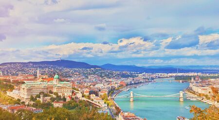 Budapest, Hungary. Beautiful aerial panoramic skyline view of historic Buda Castle Royal Palace sunrise blue sky clouds. Hungarian landmark Szechenyi Chain Bridge, Parliament building and Danube riverの写真素材