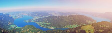 Aerial panoramic view of Austrian Alps nature, Mondsee lake from Schafberg peak near st. Wolfgang, Austria, Salzburg. Picturesque mountain lake in the summer morning landscape, large panorama bannerの写真素材