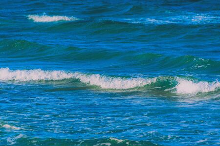 Abstract clean sea background, view on ripple foam surface of water. Deep turquoise blue ocean...
