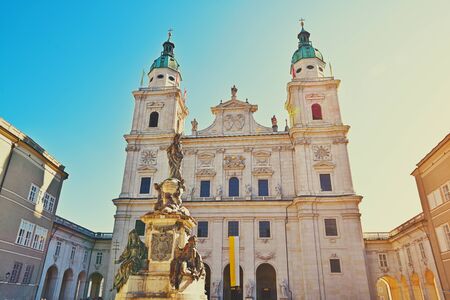 Famous Salzburg Cathedral, Salzburger Dom, at Domplatz in City Center of Salzburg Land, Austria on sunny day. Baroque roman catholic church and Marien Statue monument on square Beautiful architectureの写真素材