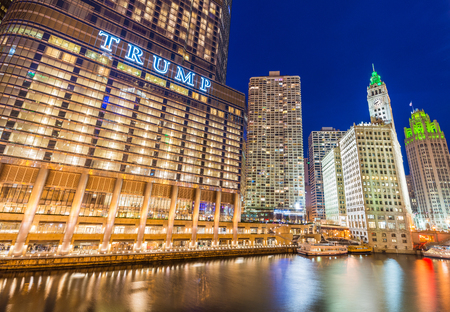 Chicago - March 2017, IL, USA: Downtown Chicago at night. View of Illuminated buildings in the central part of the city. Trump Tower and The Wrigley Building reflected in Chicago riverのeditorial素材