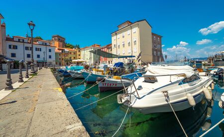 Muggia - July of 2014, Italy: Boats in harbor of the old city center in Muggiaのeditorial素材