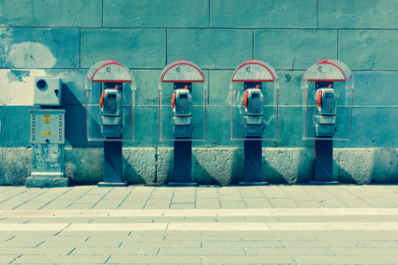 Four phone booths by the wall. Trieste, Italyの写真素材