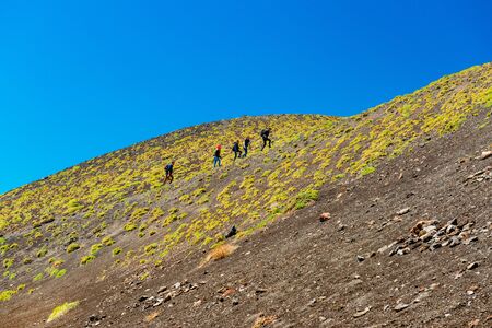 Mount Etna - May 2019, Sicily, Italy: A group of people climbing up to the top of the Mount Etnaのeditorial素材