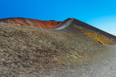 Mount Etna, Sicily, Italy: People are walking on the edge of a volcanic craterの写真素材