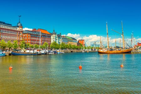 Beautiful cityscape of Helsinki, Finland. Old historical buildings, wooden ship, blue sky with cloudsの写真素材