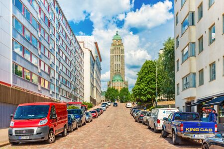 Helsinki - June 2019, Finland: View of the Kallio Church (Kallion kirkko) and a street with parked carsのeditorial素材