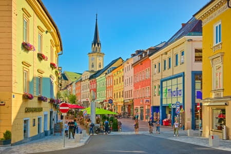 Villach - July 2020, Austria: View of the main street with colorful historical houses and the main...