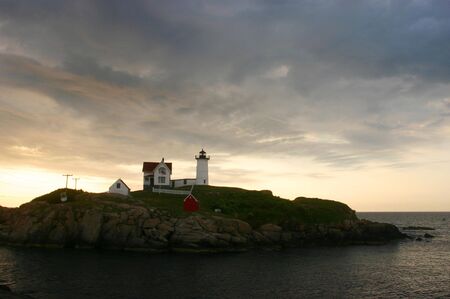 Dramatic clouds over Nubble Lighthouse in York, Maineの写真素材