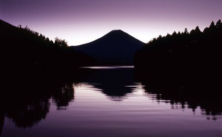 A monochromatic rendition of Mount Fuji and her reflections in a nearby lakeの写真素材
