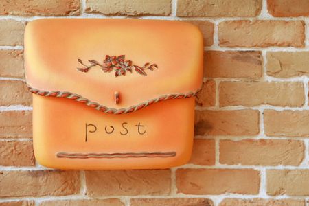 Details of a charming ceramic mailbox on the brick wall of a newly constructed homeの写真素材