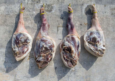 Pork shanks hanging out to dry in rural Chinaの写真素材