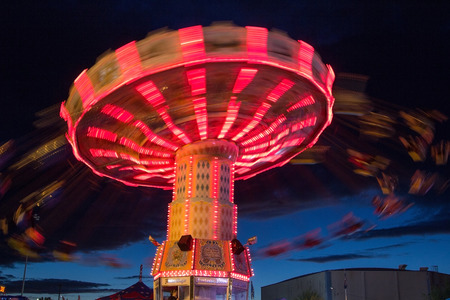 Long exposure of the Oregon State Fair swing ride at nightの写真素材