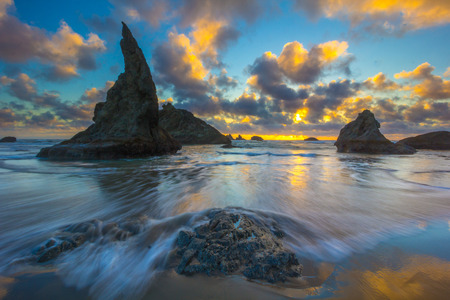 Blue and yellow sunset with seastacks at Bandon, Oregonの写真素材