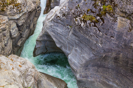Rocks eroded by the power of quickly flowing water of the North Saskatchewan River in Alberta, Canadaの写真素材