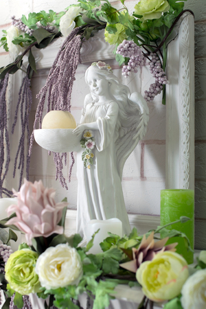 angel figurine in flowersの写真素材