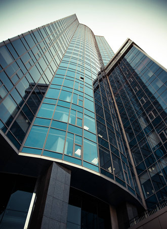 Bottom view on skyscraper on a background of blue sky