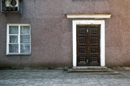 old house, wall with grunge old door, textureの写真素材