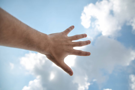 The hand touching the blue skyの写真素材