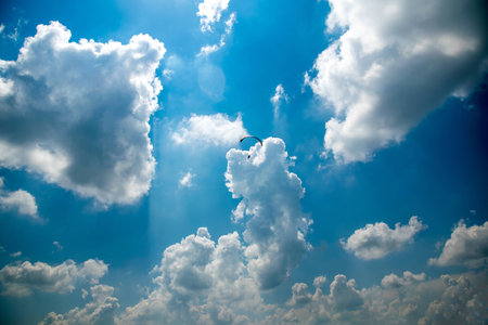 Paraglider in the blue sky, big blue cloudsの写真素材