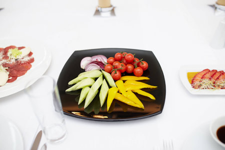 vegetables on a black plateの写真素材