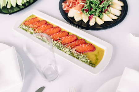 snacks on the table, fish, vegetables, fruitsの写真素材