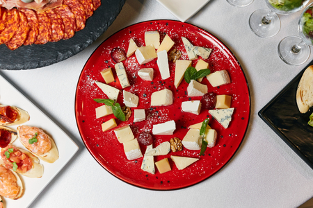 snacks, cheese on a red plate, buffetの写真素材