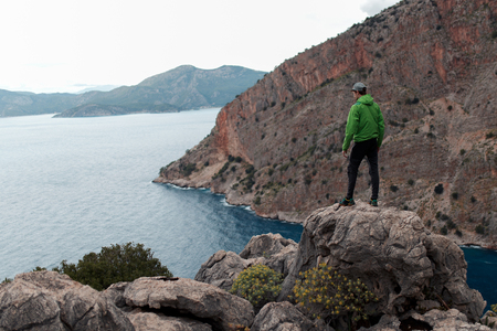 man on top of mountain, big bay in the sea, top viewの写真素材