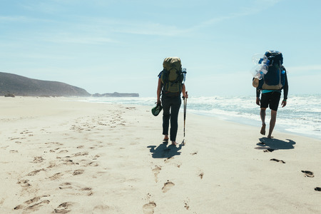 couple tourists walking on the beachの写真素材