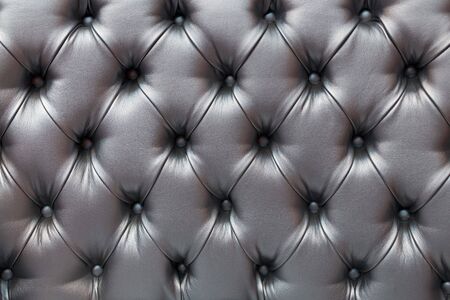 Light gray horizontal elegant leather texture with buttons for background and designの写真素材