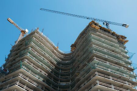 Bottom view on building skyscraper on a background of blue sky