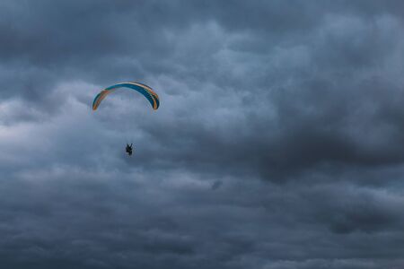Paraglider in the dark skyの写真素材