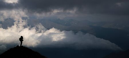 silhouettes of people in the mountainsの写真素材