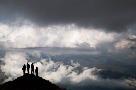 silhouettes of people in the mountainsの写真素材