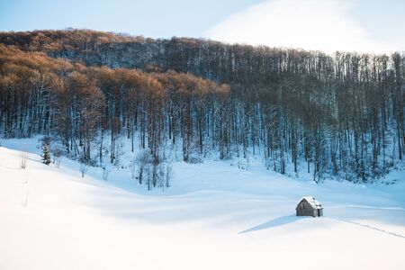 abandoned house in the mountains in winterの写真素材