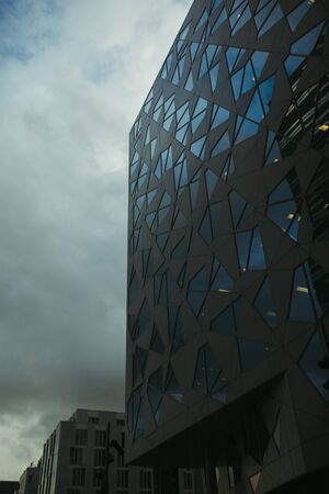 building with black facade in norway in cloudy weatherの写真素材