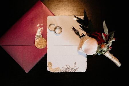 gold wedding rings on beautiful paper on a background of roses and letters
の写真素材