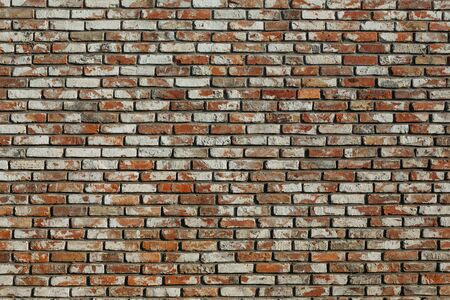 old brick wall with different bricks, background textureの写真素材