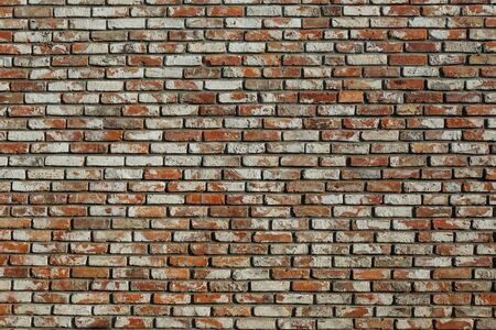 old brick wall with different bricks, background textureの写真素材