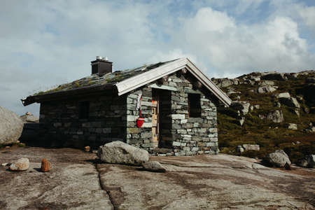 lifeguard house in the mountains of norway against mountains and blue skyのeditorial素材