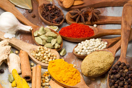 Aromatic spices on wooden spoons. Food ingradients.の写真素材