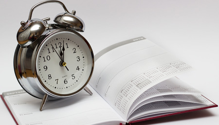alarm clock and diary on a white background. For time concept.の写真素材