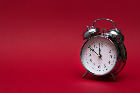 red alarm clock on red background. close up shot. top view. For time concept.の写真素材
