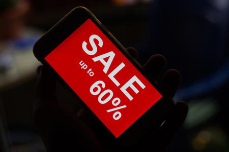 Black friday and sale inscription on smartphone screen. inscription SALES on the screen of a mobile phone.の写真素材