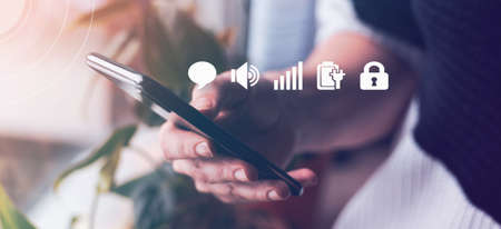 Close up woman hand holding smartphone with virtual interfaceの写真素材