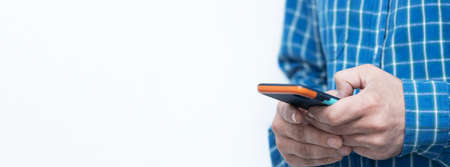 Hands of man typing text on mobile smartphone. Online chat chatting on application communication digital media website and social network.の写真素材