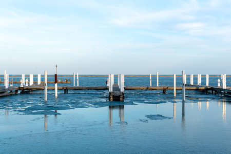 Boat docks with icy water.の写真素材