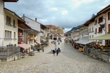 Gruyeres, Switzerland - 17 April, 2016: People walking, resting in little town on holiday at Gruyeres, Switzerland. Gruyeres is the medieval town, famous tourist destination and home  of the cheese.のeditorial素材