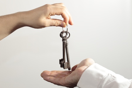 Woman's hand gently holding a bunch of retro keysの写真素材