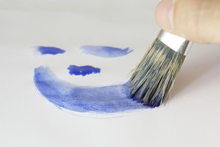 brush is painting blue lines on paper